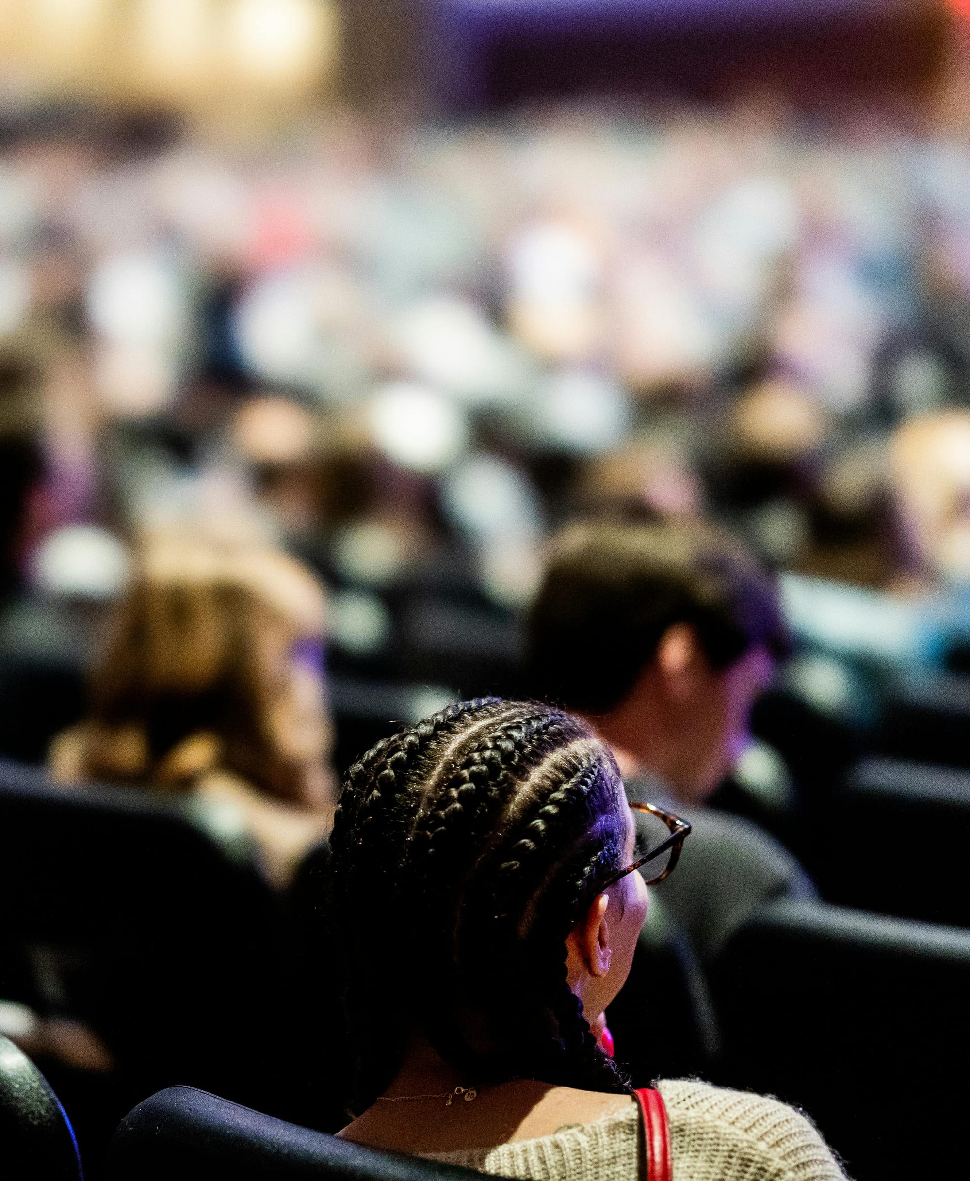 A group of people sit in an auditorium.