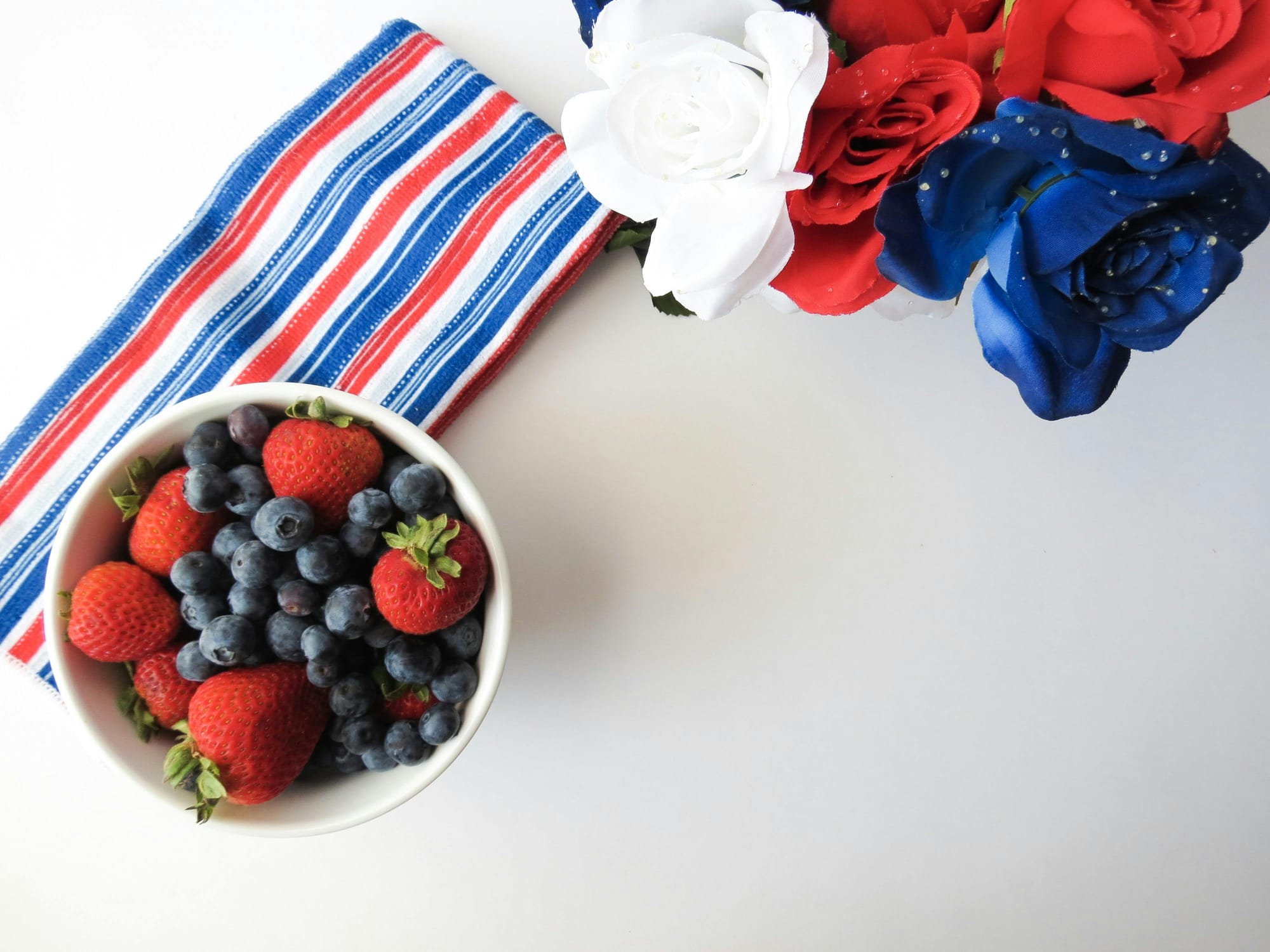 red, white, and blue flowers, fruit, and napkin 