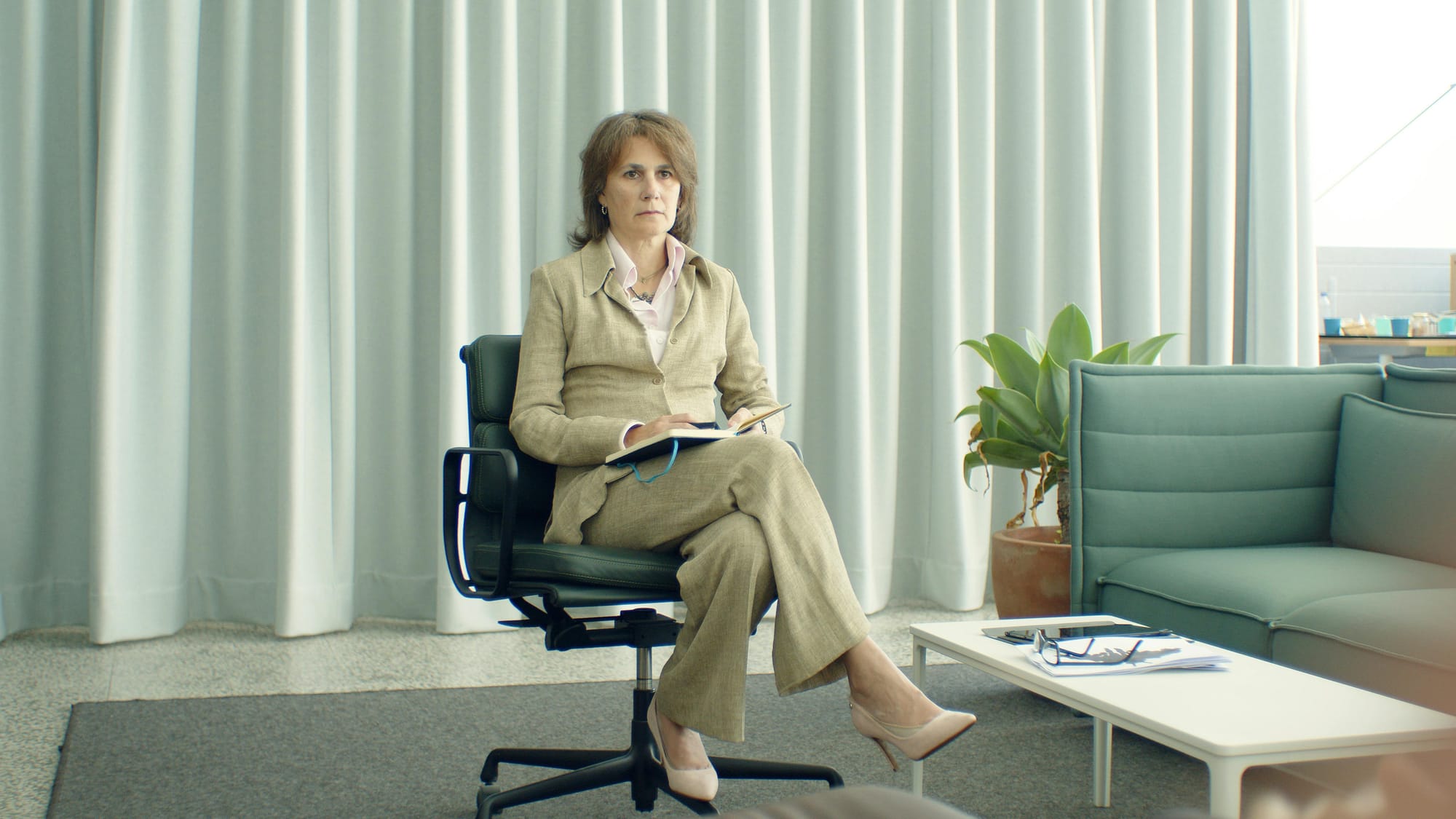 Woman in Brown Coat Sitting on Black Office Rolling Chair. Licensed facilitators will be able to administer psychedelic-assisted therapy if Question 4 is approved.