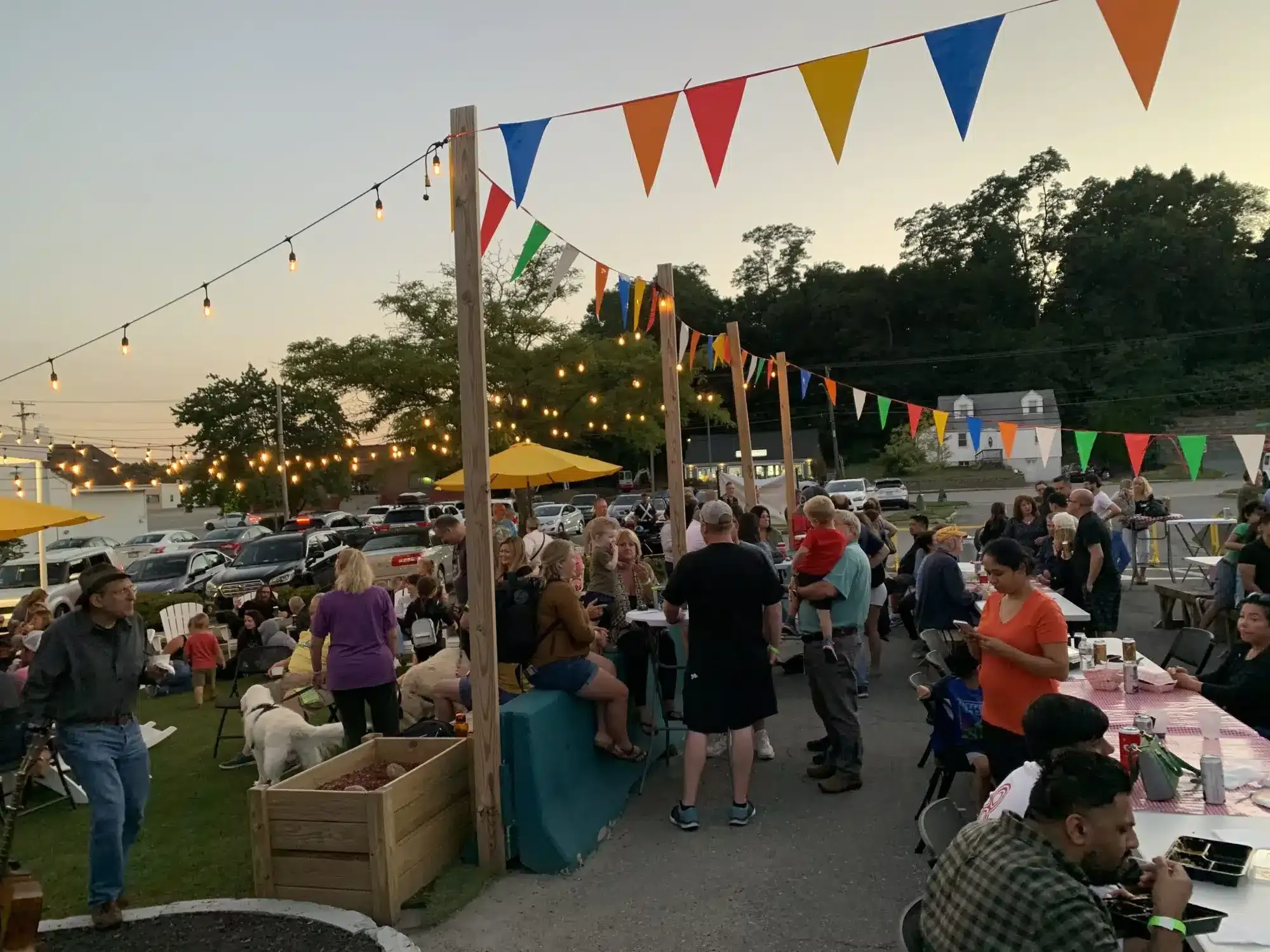 People mill about and eat at a 2023 Beer Garden event.