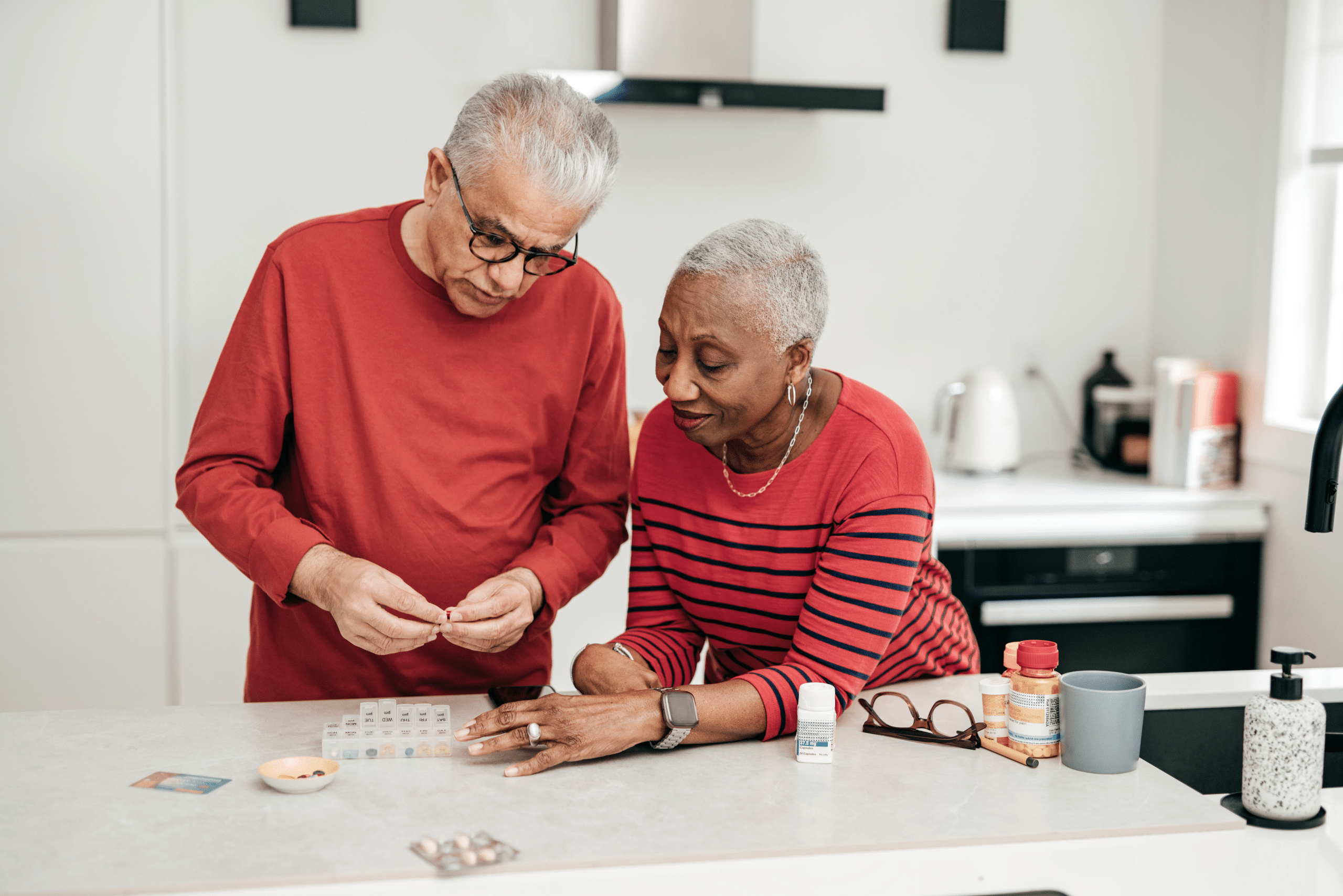 patient couple filling pill dispenser